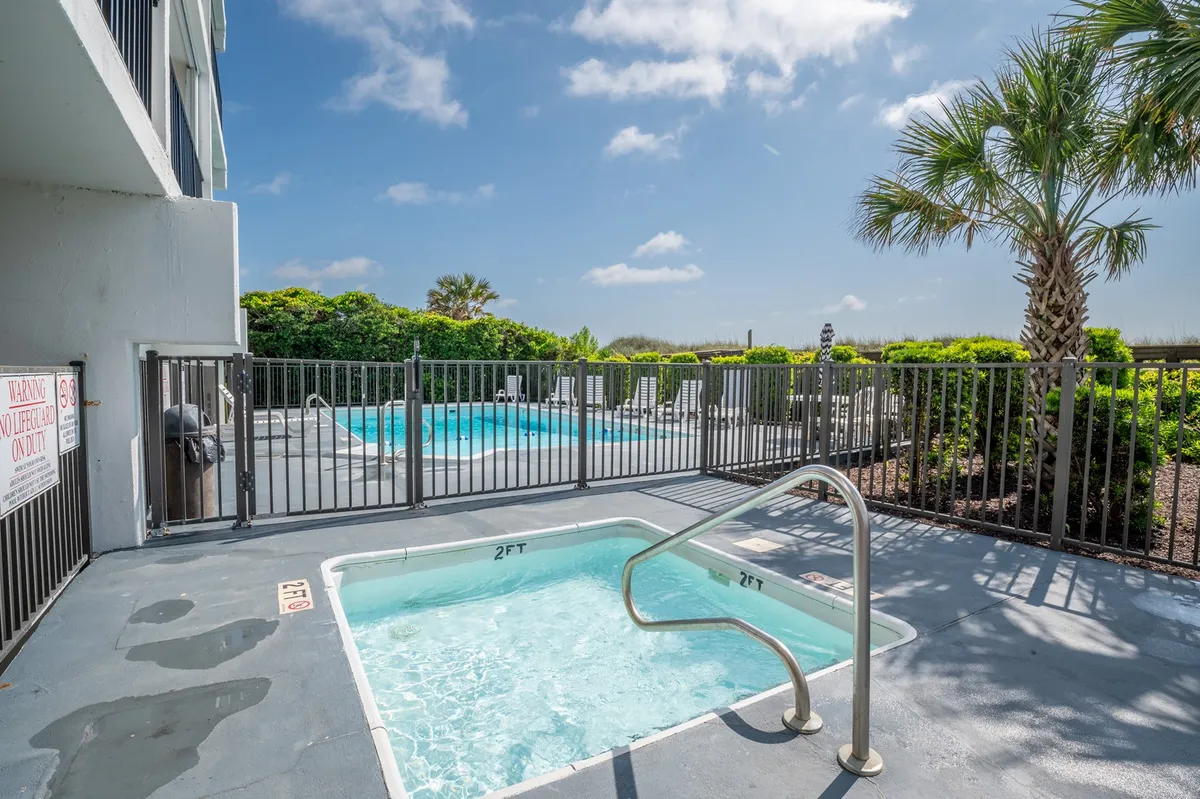 A sparkling swimming pool and inviting jacuzzi surrounded by palm trees, evoking a sense of relaxation and luxury. The setting is ideal for unwinding after a day of adventure or sharing a quiet evening together.